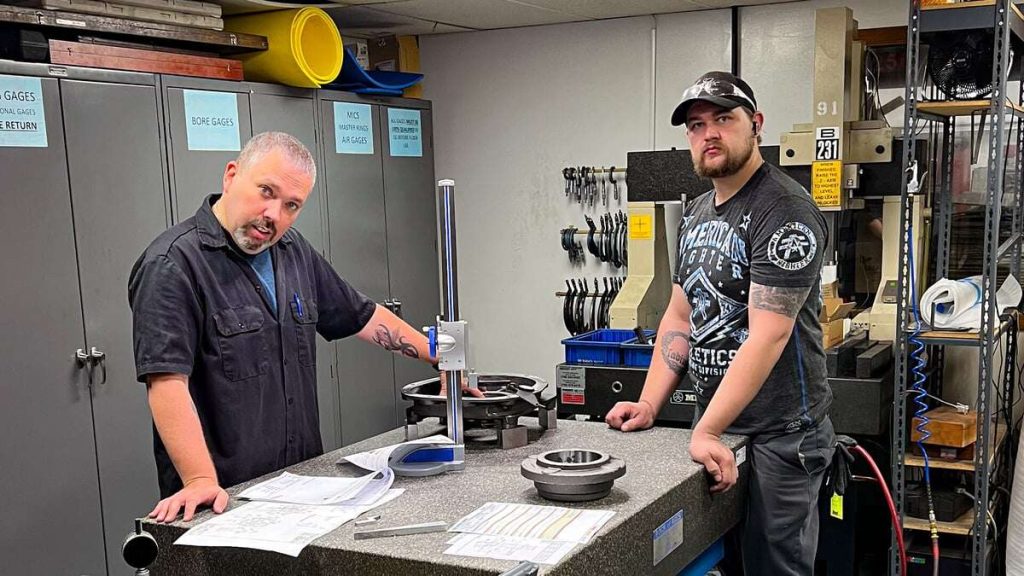 Eagle CNC staff measuring a part to adjust tooling and fixtures for first article approval